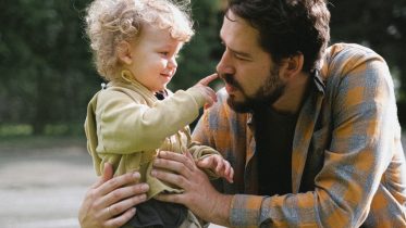 Kid pointing to dads nose